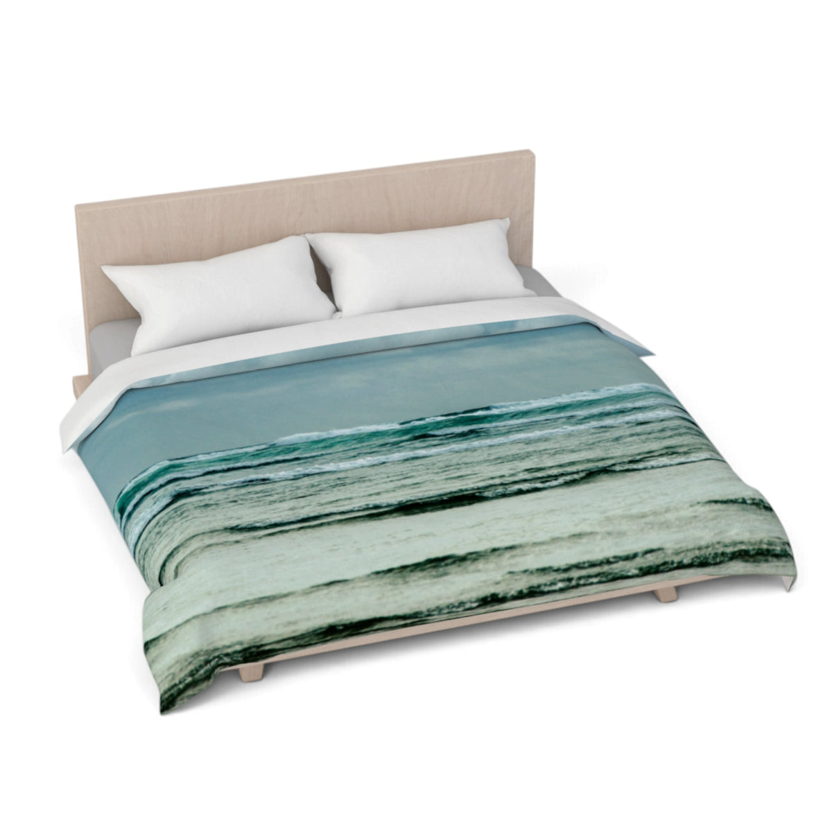 A bed with a light wood headboard and white pillows, styled with a duvet cover featuring an abstract ocean wave pattern in shades of teal, green, and blue.