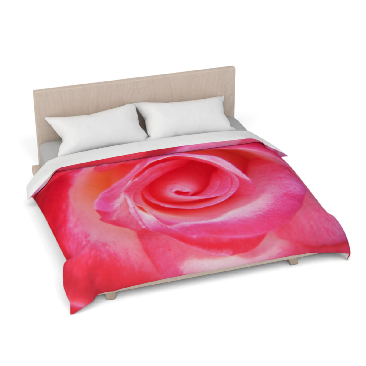 A bed dressed with a duvet cover featuring a large close-up pink rose print, shown with two white pillows and a light wood headboard on a white background.