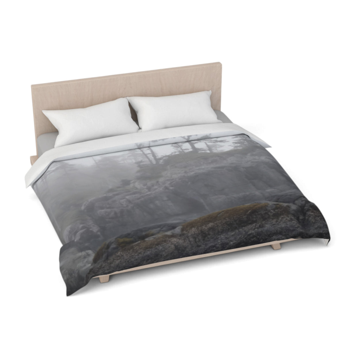A bed dressed in a duvet cover featuring a moody gray and black forest scene with a dark foreground, styled with two white pillows and a light wood headboard on a white background.
