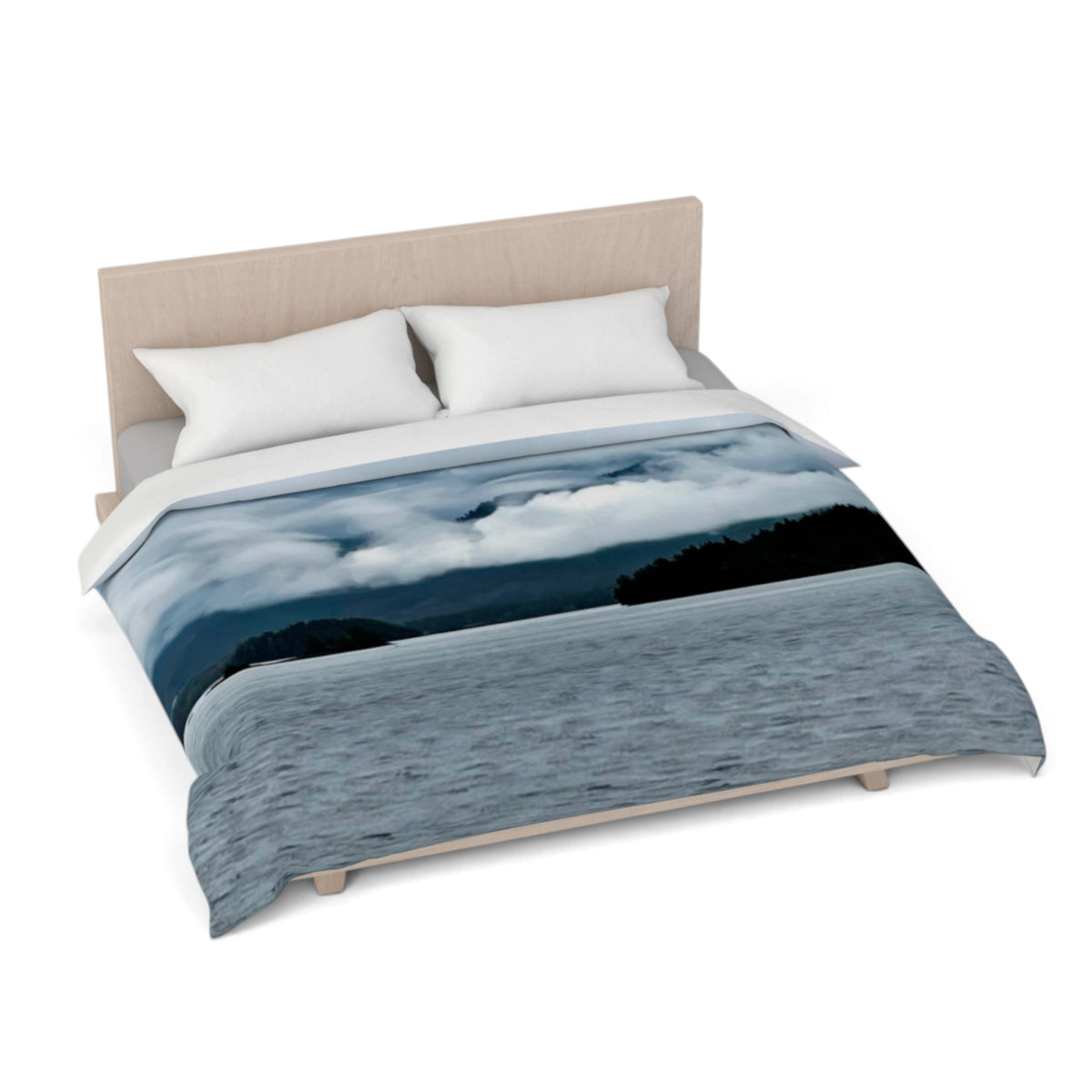 A bed dressed with a duvet cover featuring a scenic landscape print of a lake under a cloudy sky, styled with two white pillows and a light wood headboard on a white background.