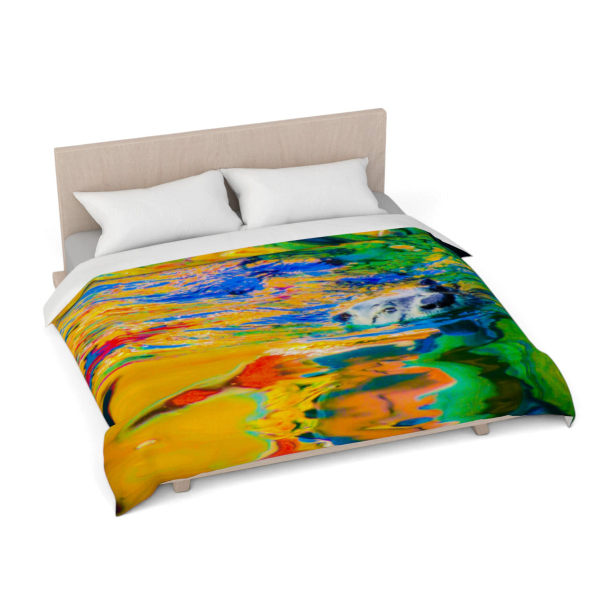 A bed dressed with a colorful abstract print comforter and white pillows, shown on a white studio background with a light wood headboard.
