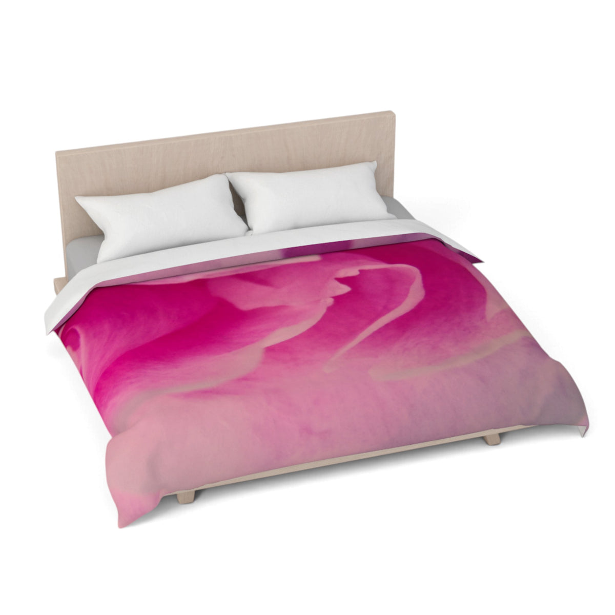 A bed with a vibrant pink and magenta abstract watercolor duvet cover, styled with two white pillows and a light wood headboard against a white background.