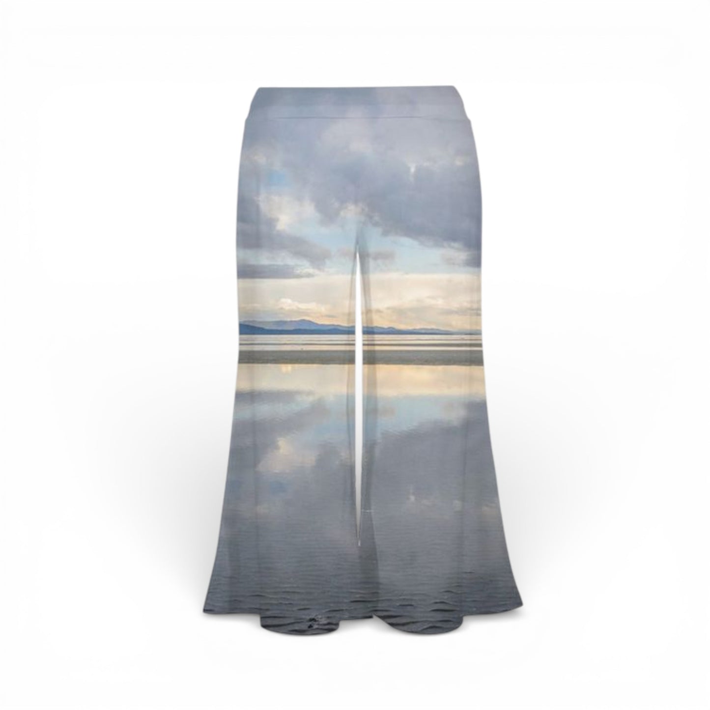 Pants with a scenic print of trees and water on a white background