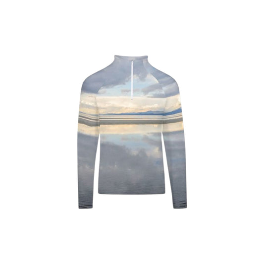 All over print men's active half zip long sleeve top with an image of the early morning light at the beach on Vancouver Island.  The soft colours of the sky reflect in the still of the ocean water.
