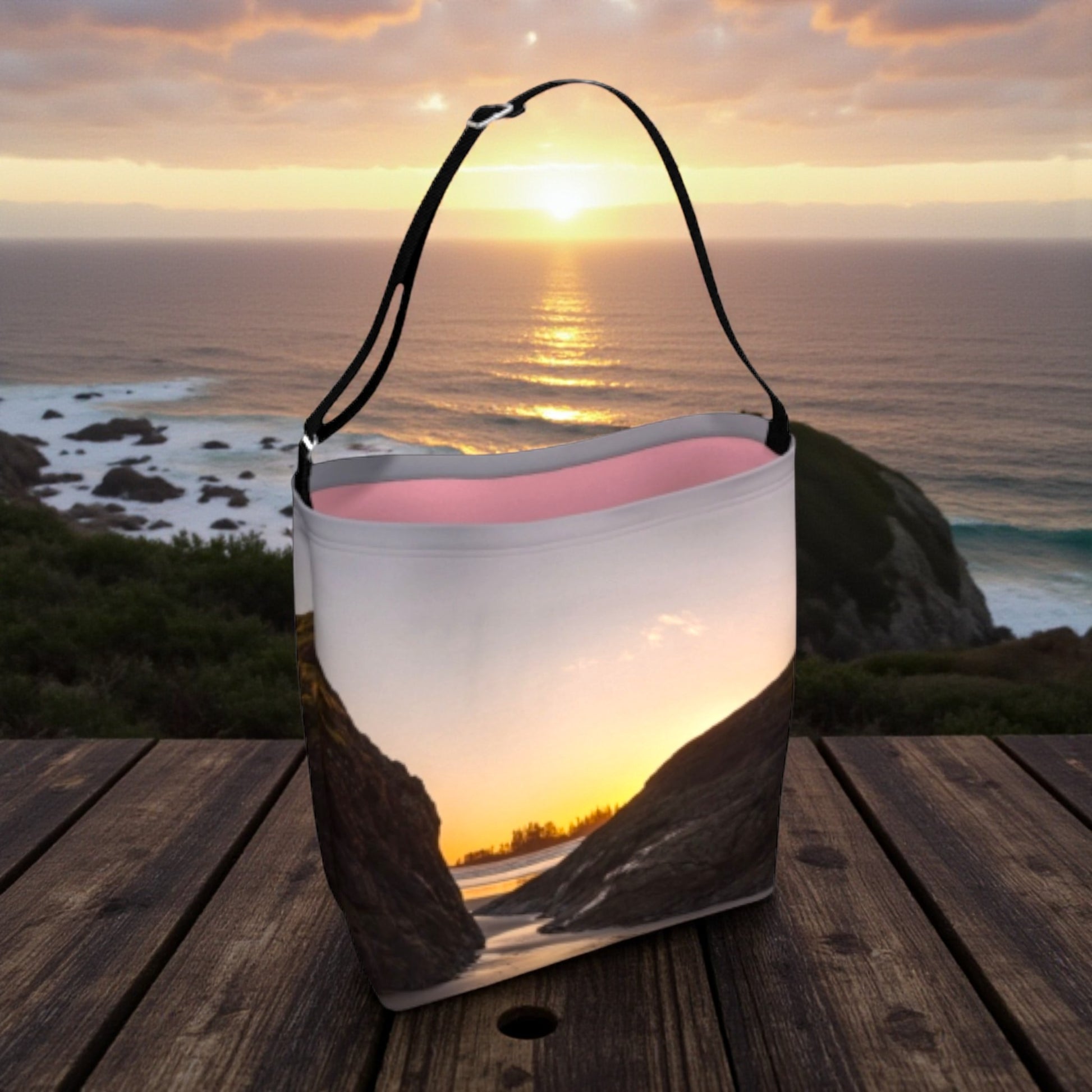 tote bag with sunset design on a wooden surface with ocean view