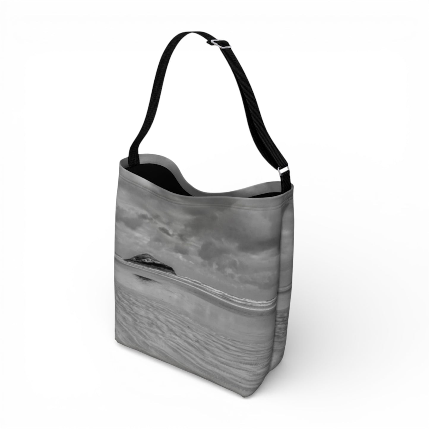 Gray crossbody bag with a black strap on a white background