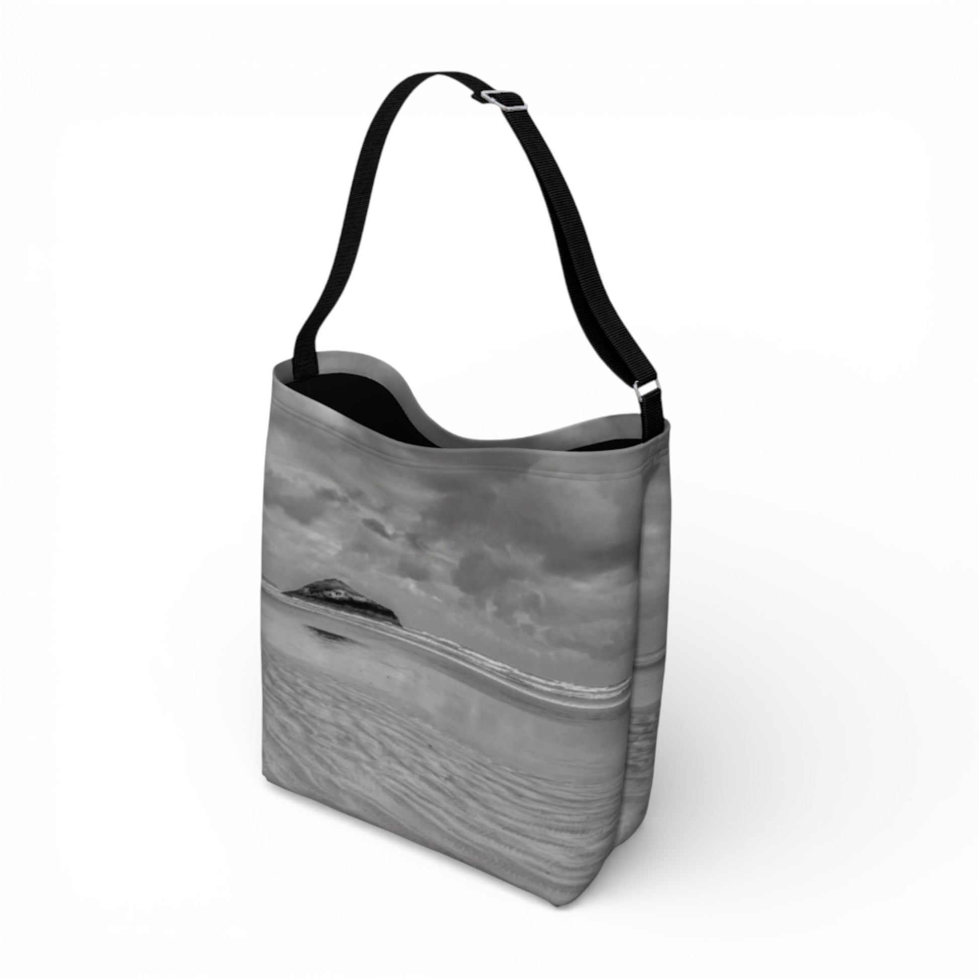 Gray crossbody bag with a black strap on a white background