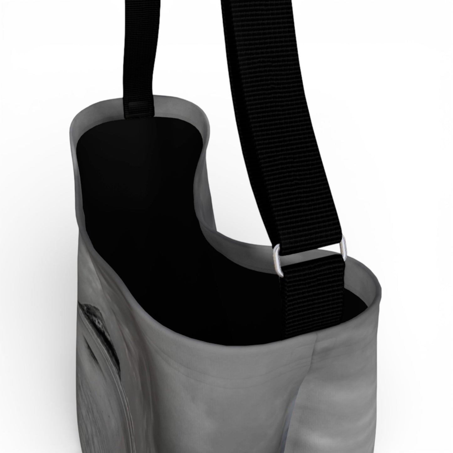 Gray bag with a black strap on a white background