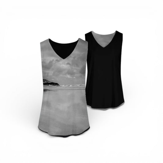 Two tank tops, one with a scenic design and one black, on a white background