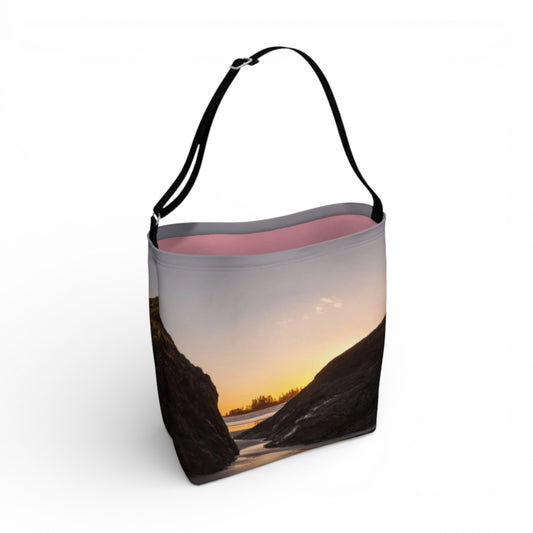 Tote bag with a scenic design of a sunset over water on a white background