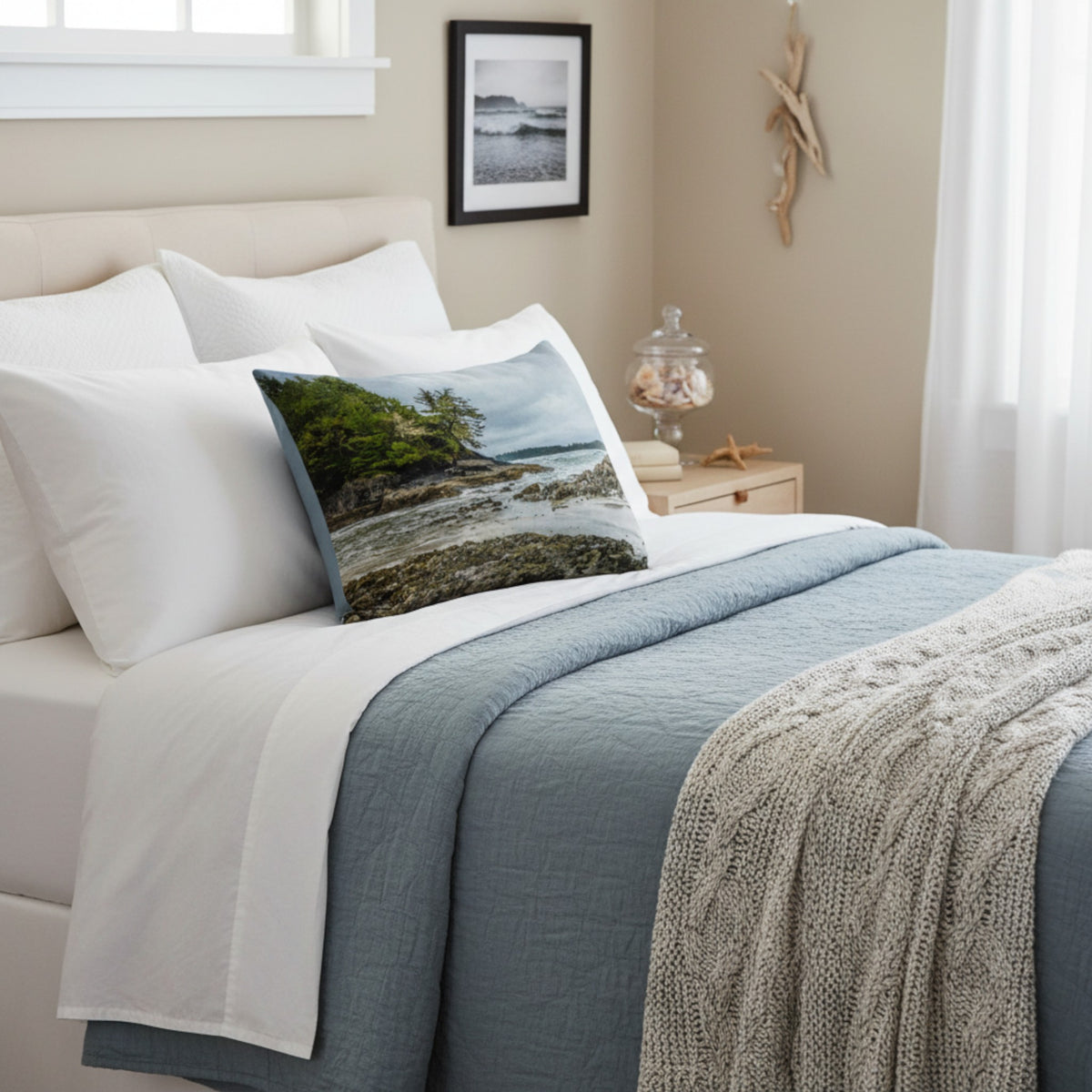 A throw pillow cover featuring an image of a coastal scene with rocks and trees on a beach.