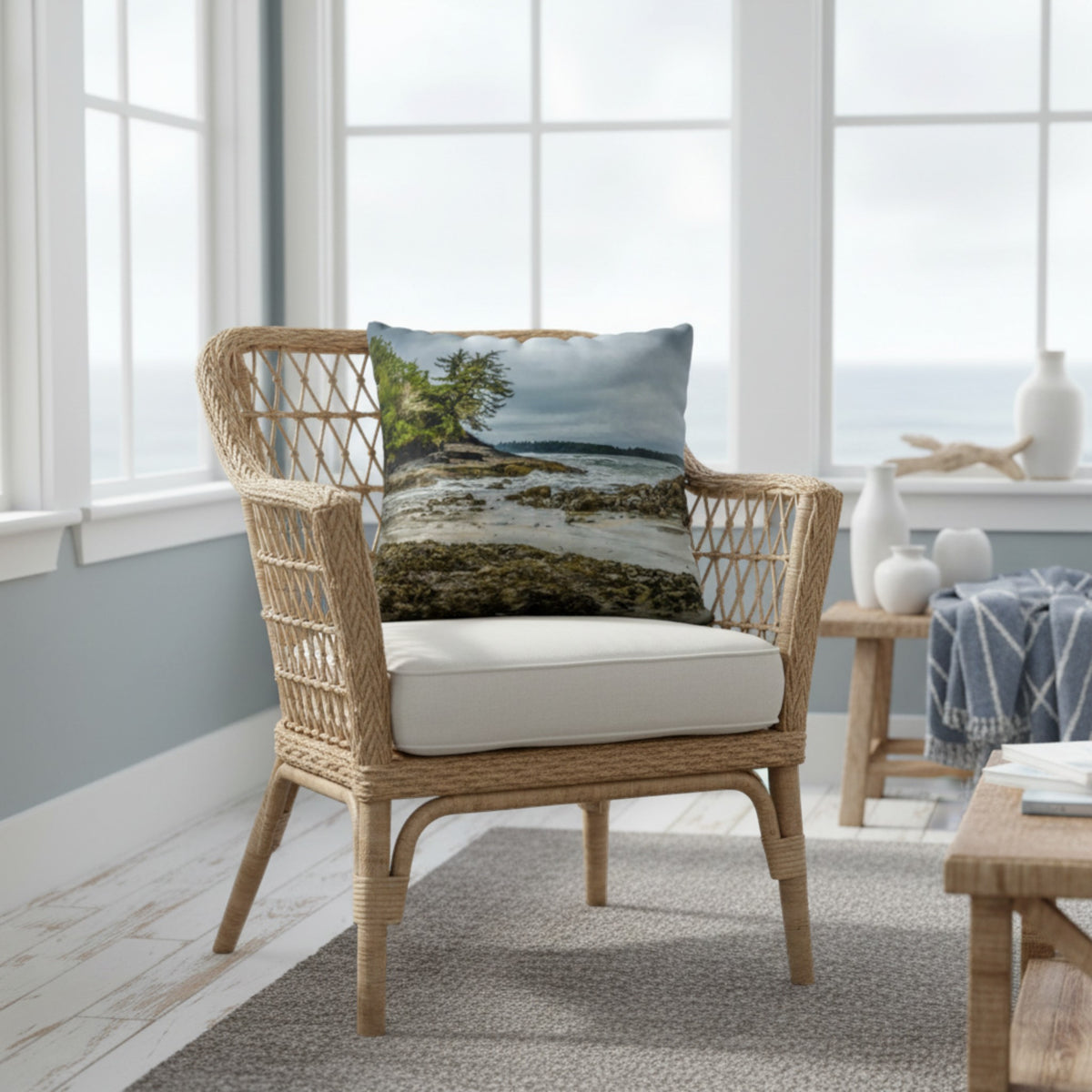 A throw pillow cover featuring an image of a coastal scene with rocks and trees on a beach.