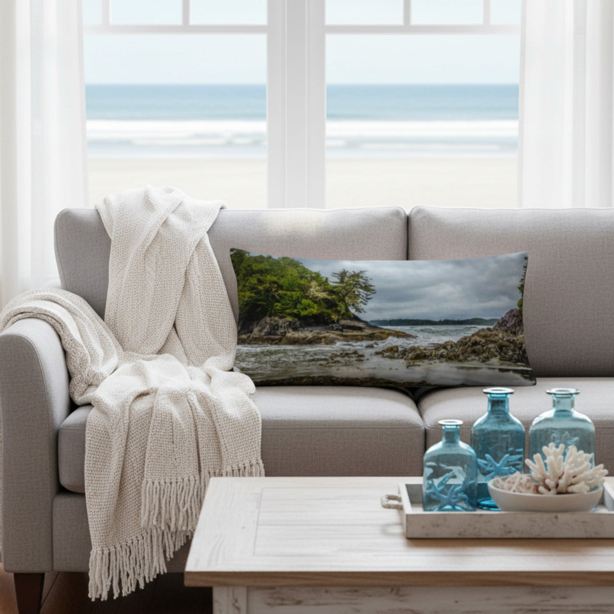 A throw pillow cover featuring an image of a coastal scene with rocks and trees on a beach.