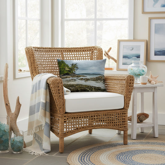 A throw pillow cover featuring an image of a coastal scene with rocks and trees on a beach.