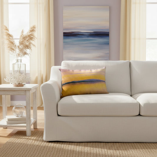 A throw pillow with a vibrant image of a sunset over a body of water, with mountains in the background.