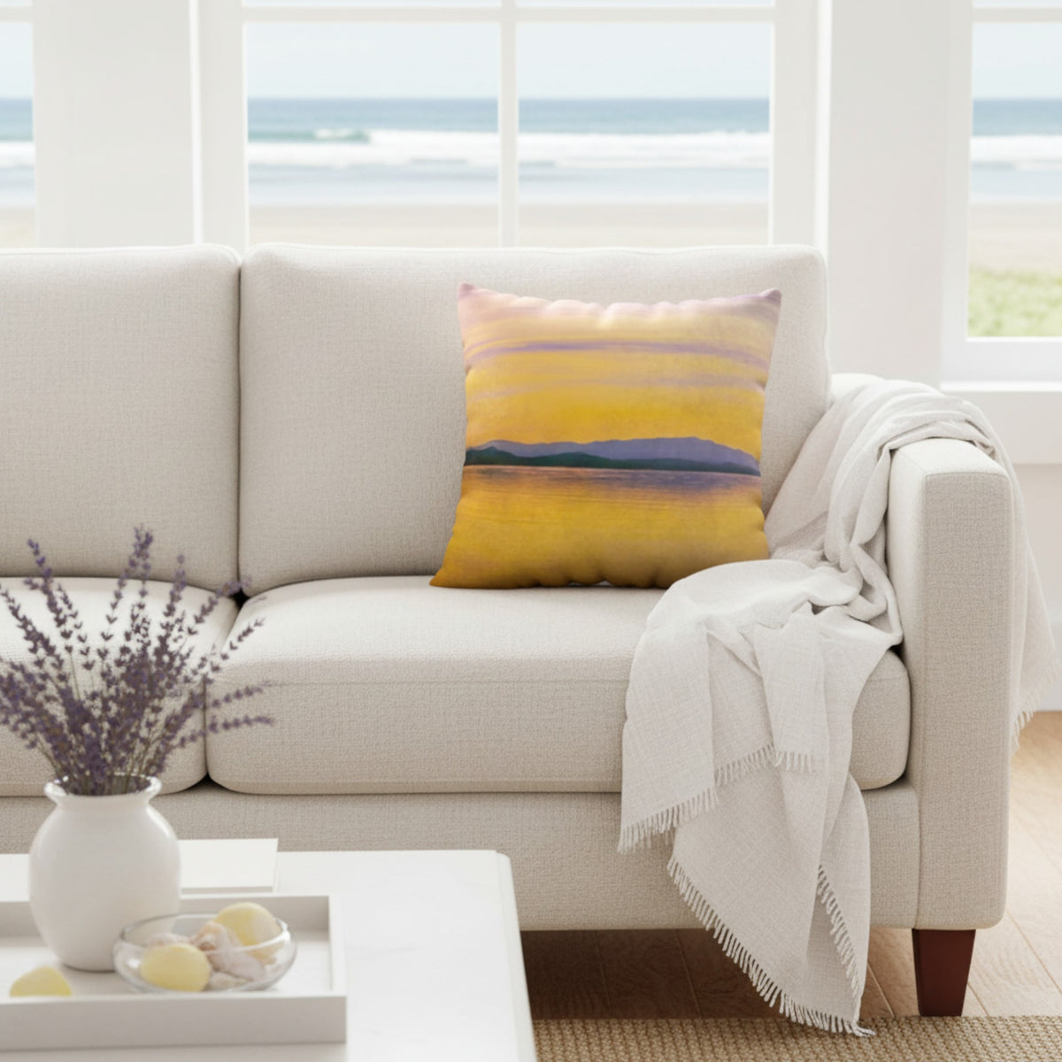 A throw pillow with a vibrant image of a sunset over a body of water, with mountains in the background.