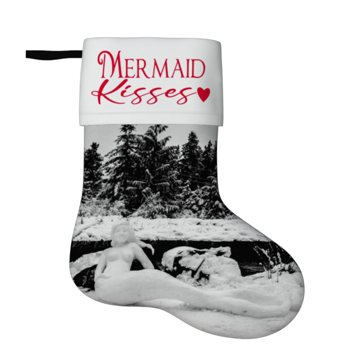 A novelty Christmas stocking with a white cuff printed with the words 'MERMAID Kisses' in red script and a small red heart. The body of the stocking features a black-and-white photograph of a snowy mermaid on a log by a forest.