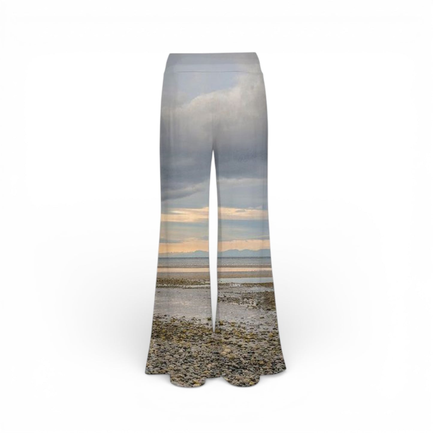 Flared pants with a scenic print of a beach and sky on a white background