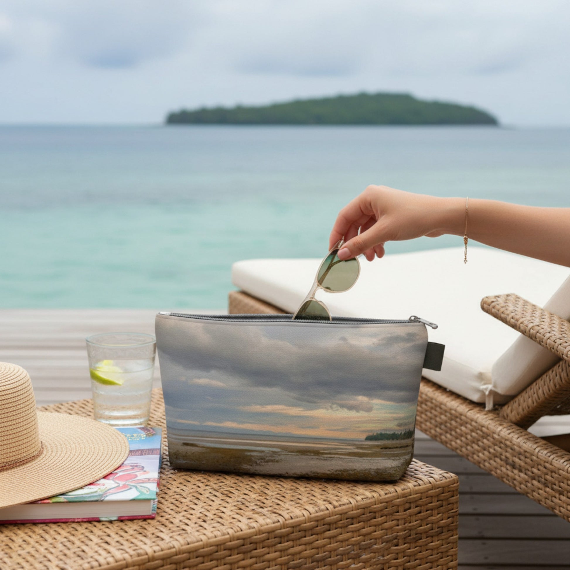 Person reaching into a pouch with a scenic design by the ocean