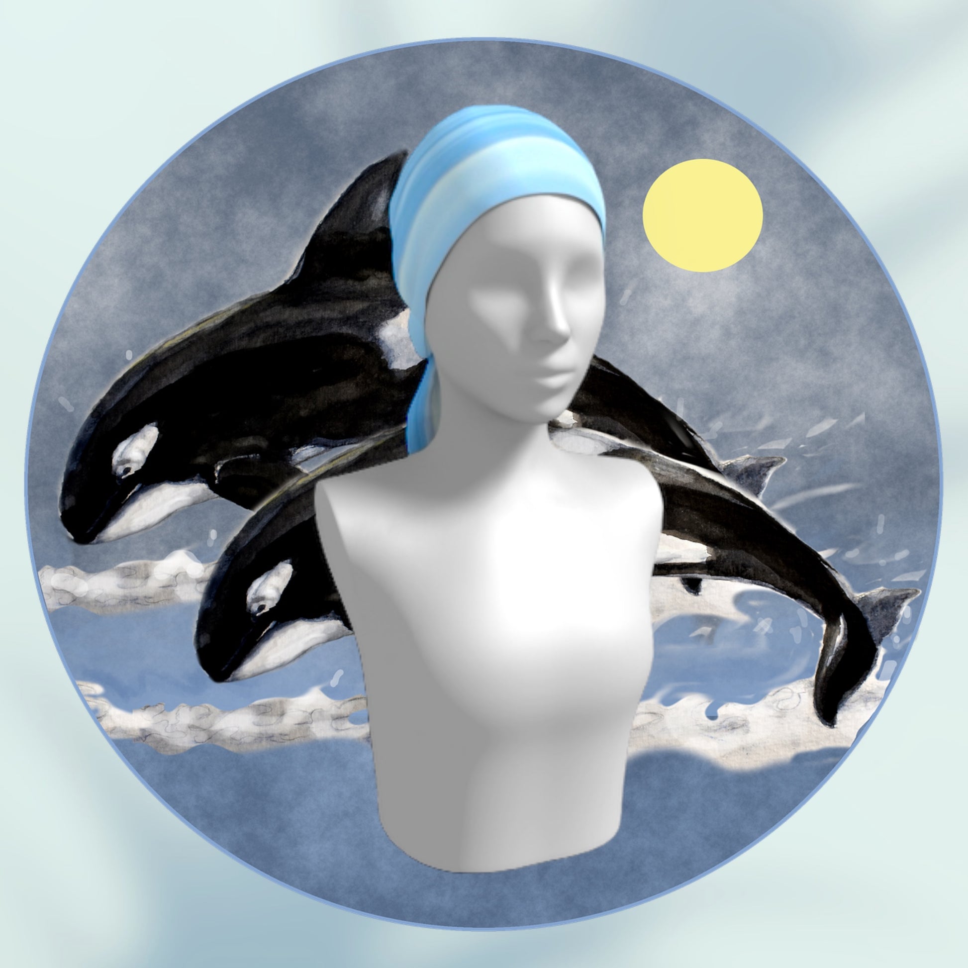 Ocean blue horizon long scarf is shown worn as a head wrap and two orcas are behind the manniquin.