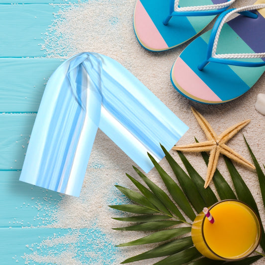 Ocean Blue long scarf is shown on the deck with sand, sandals, starfish and a drink