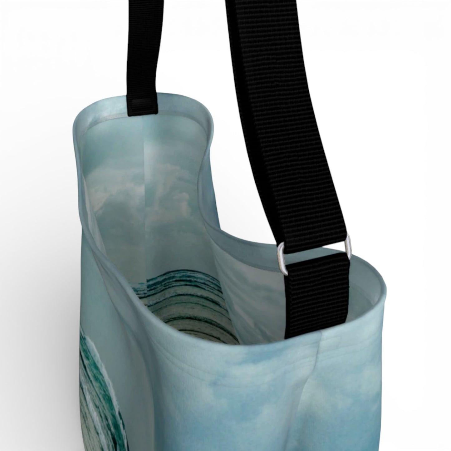 Light blue tote bag with a black strap on a white background