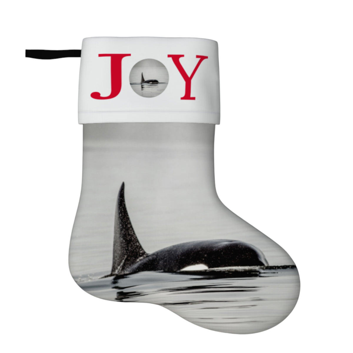 A Christmas stocking with a white cuff printed with the word 'JOY' in red, where the O is represented by a circular cutout showing an orca. The body of the stocking features a photographic print of an orca in water.