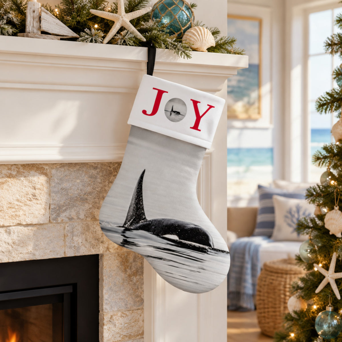 A personalized Christmas stocking hanging from a stone fireplace mantel. The stocking is white with a black-and-white orca print on the lower half, a white cuff with red embroidered letters 'JOY', and a black hanging loop.