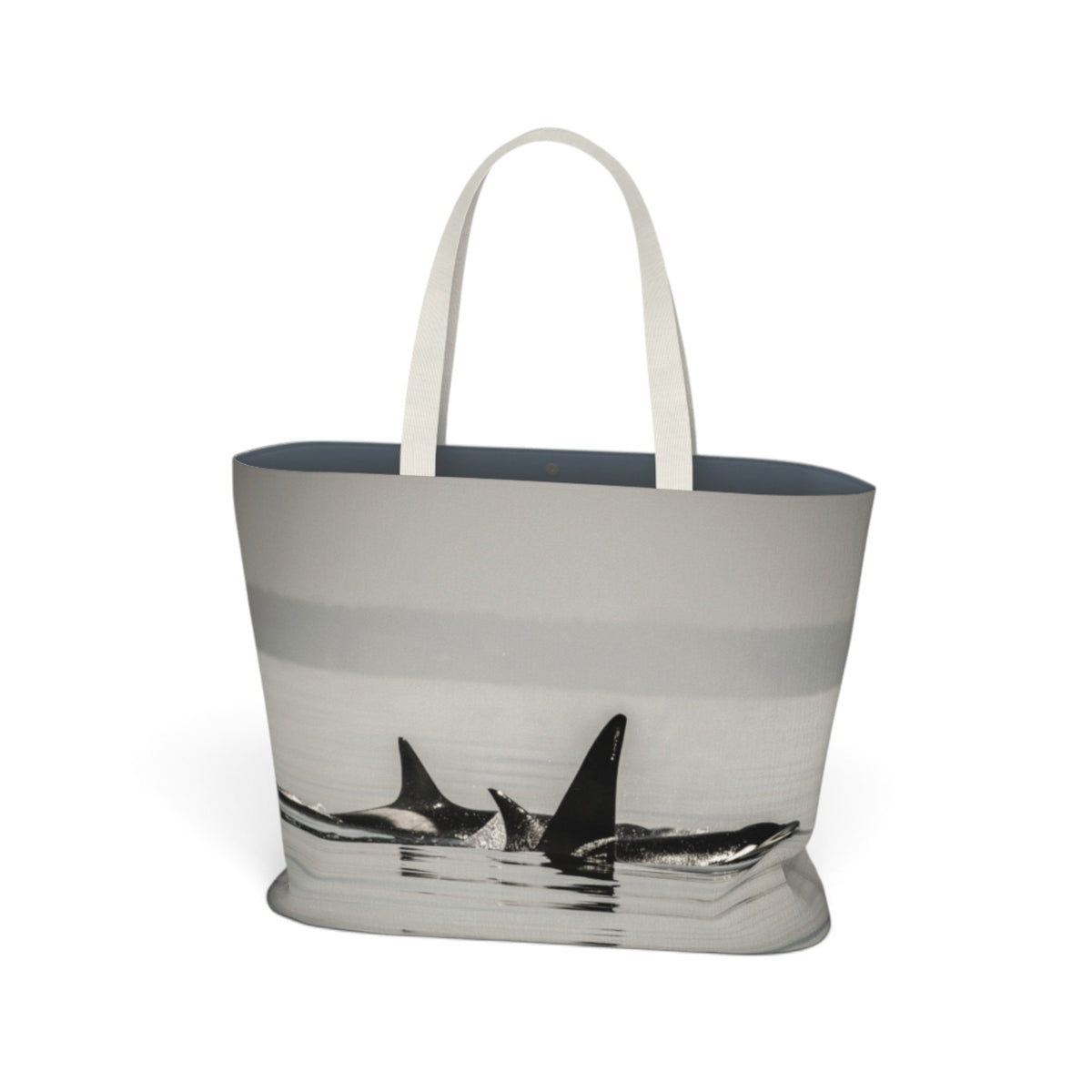 A tote bag featuring a grayscale photographic print of killer whales surfacing from the water, with solid white shoulder straps, set against a plain white background.