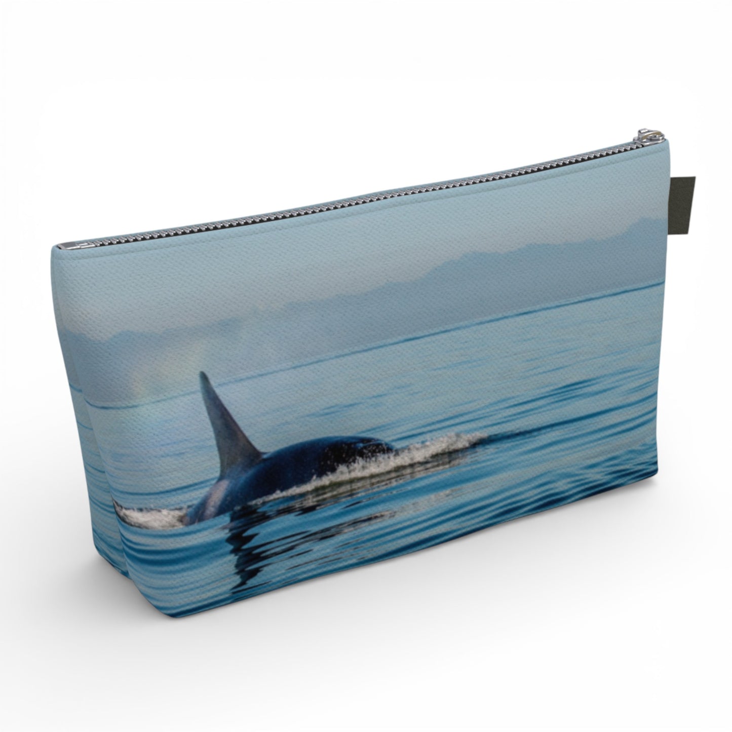 Pouch with an orca whale design on a blue water background