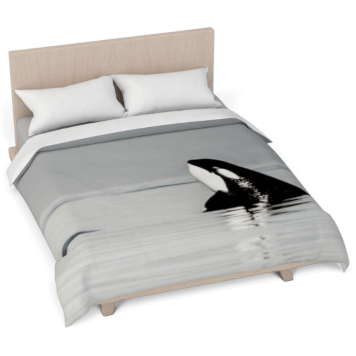 A bed dressed in a duvet cover featuring a black and white orca whale print on a gray water-textured background, styled with two white pillows and a light wood headboard.