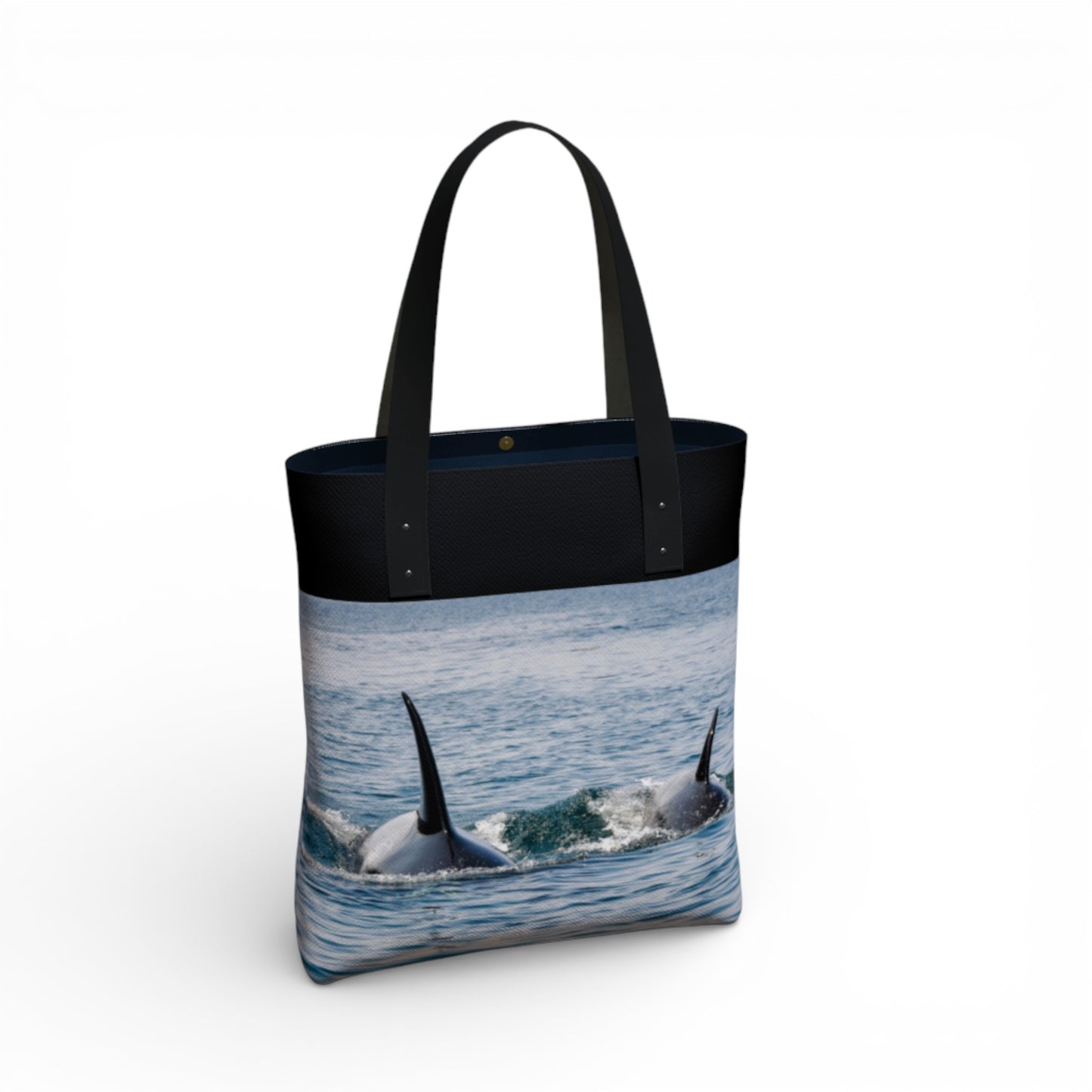 Tote bag with orcas in the water design on a white background