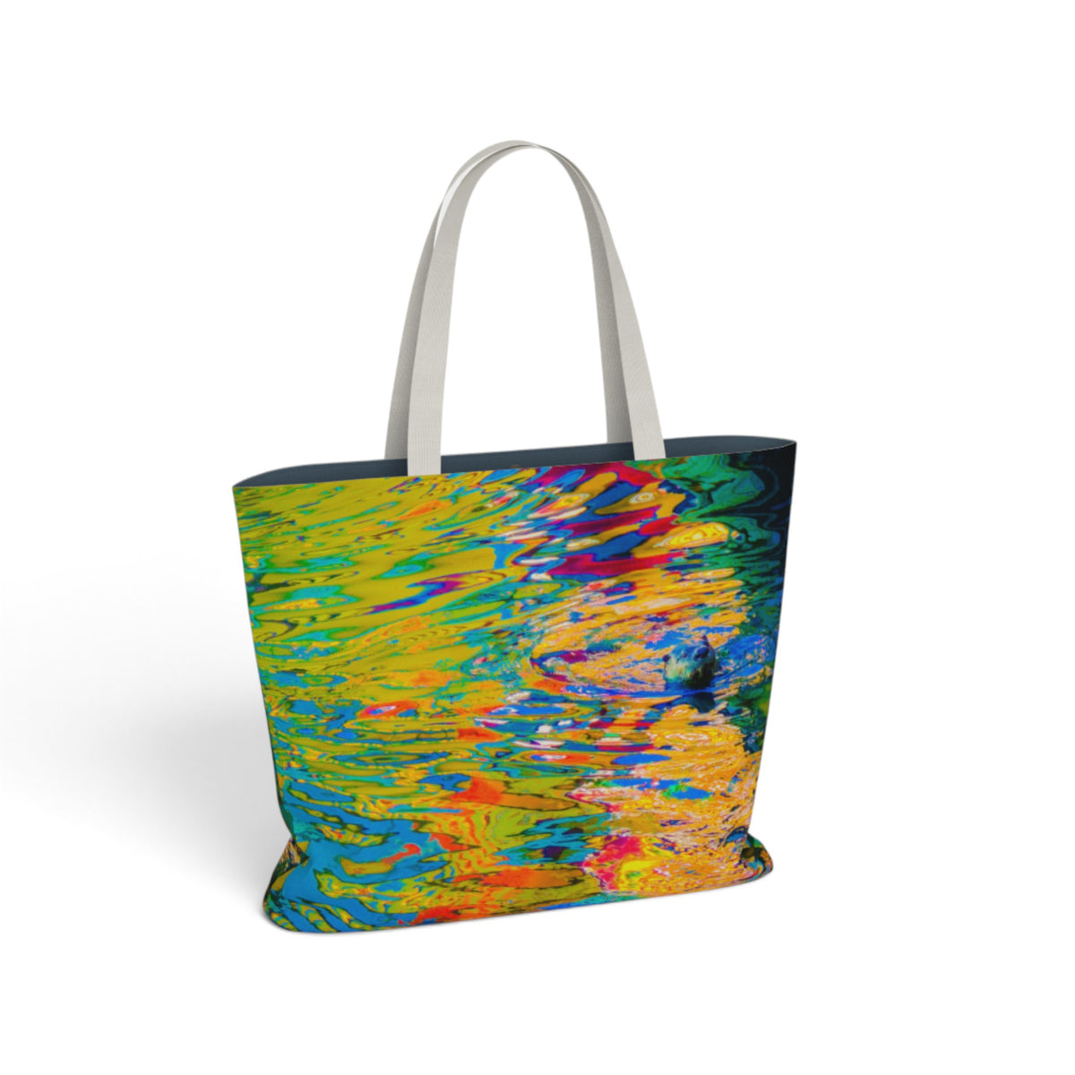 A tote bag with a vibrant, multicolored abstract print resembling rippling water, featuring white shoulder straps, shown on a clean white background.