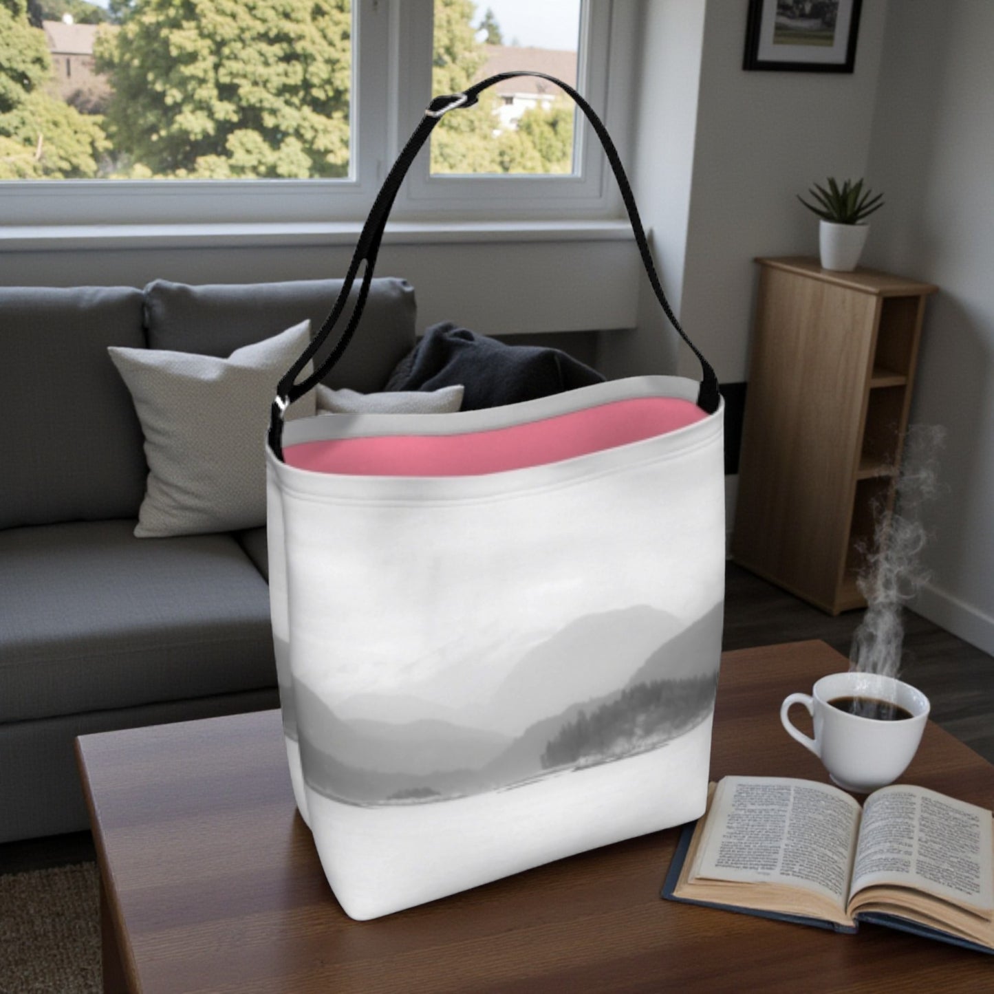 White tote bag with pink interior on a table in a living room setting