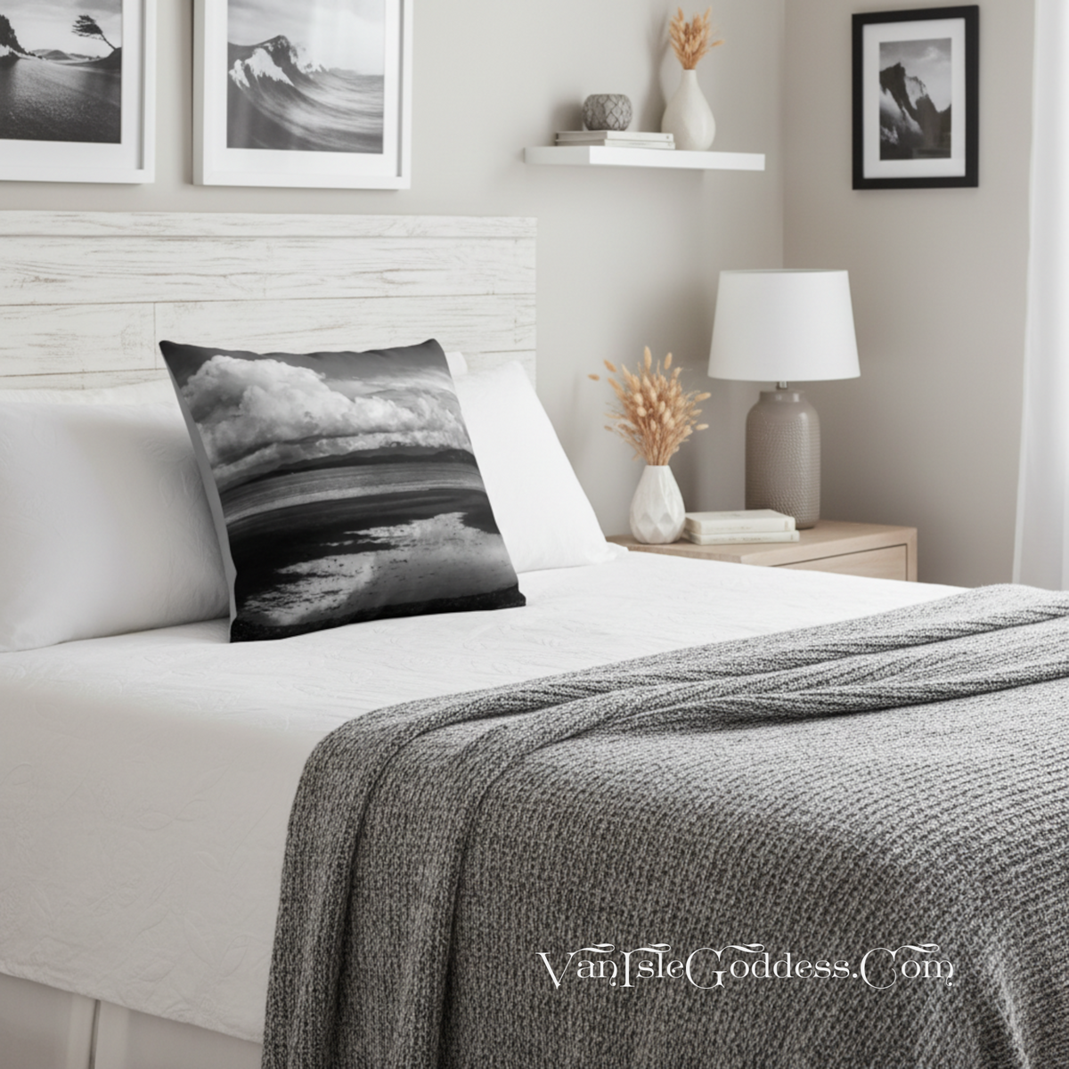 A black and white landscape throw pillow displayed on a neatly made bed in a modern, neutral-toned bedroom setting.