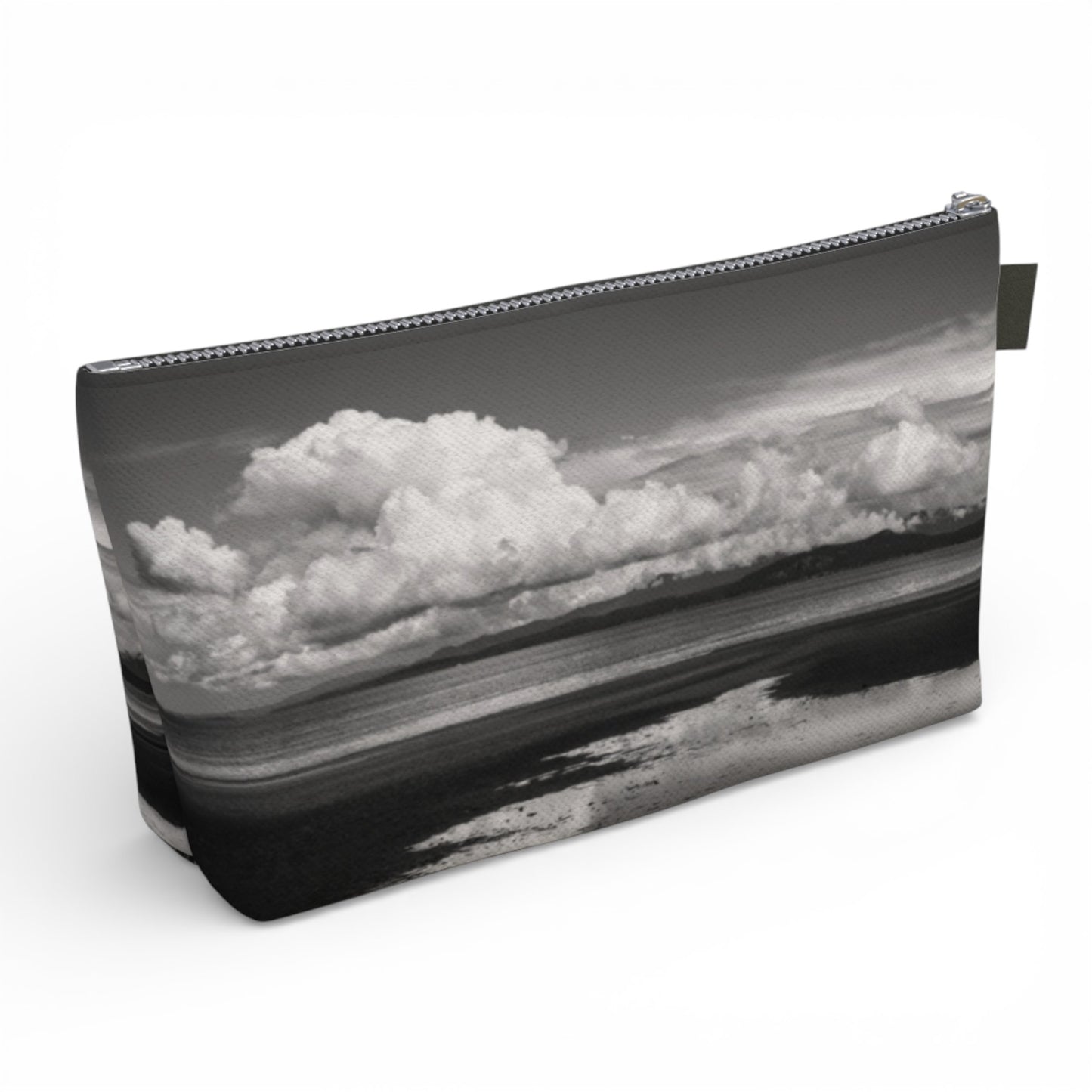 Pouch with a black and white landscape design featuring clouds and water.