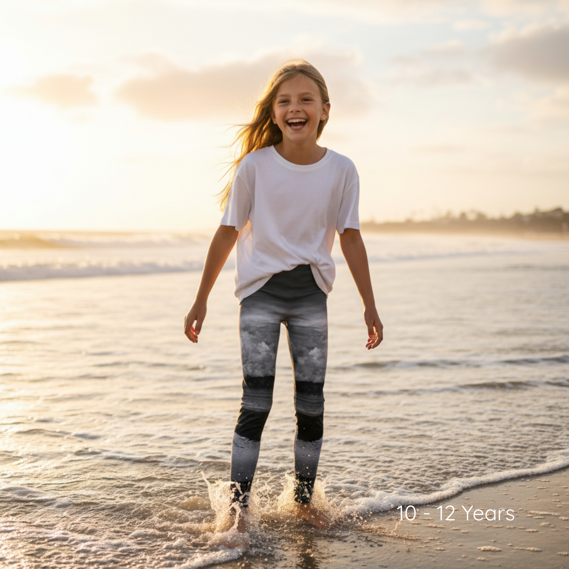 Young girl playing in the water at the beach with a sunset in the background