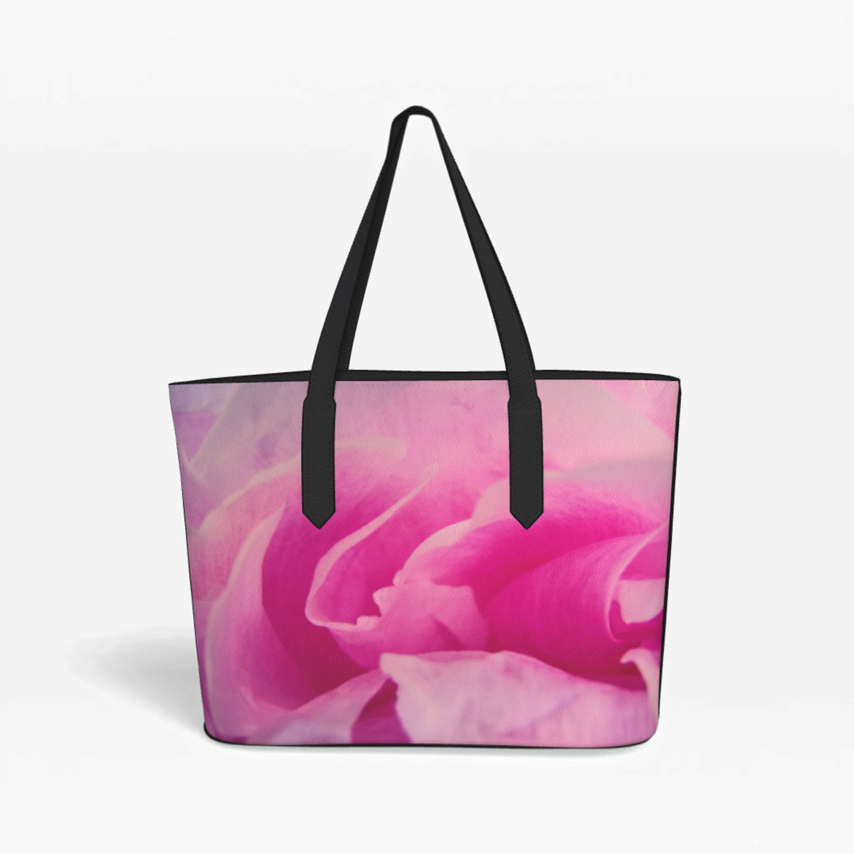 A tote bag featuring a vibrant pink rose print on the front, with black shoulder straps and black trim, shown against a plain white background.