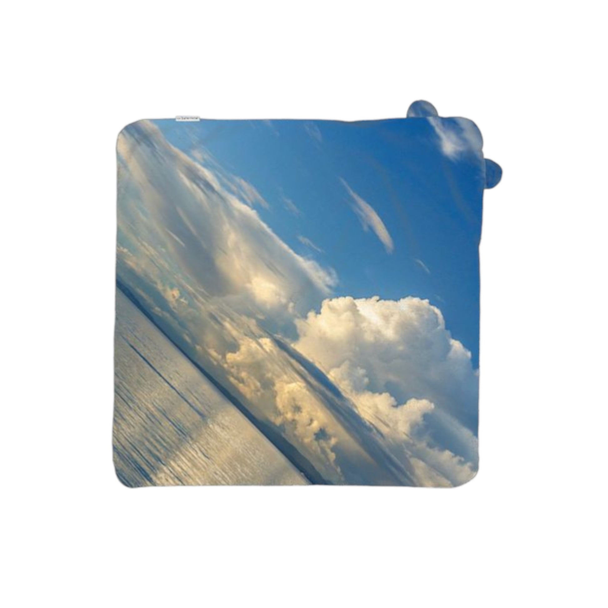 Rectangular towel with a design of clouds and blue sky on a white background