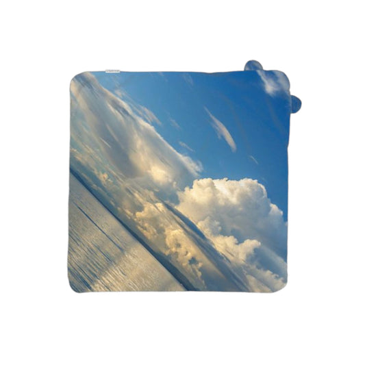 Rectangular towel with a design of clouds and blue sky on a white background