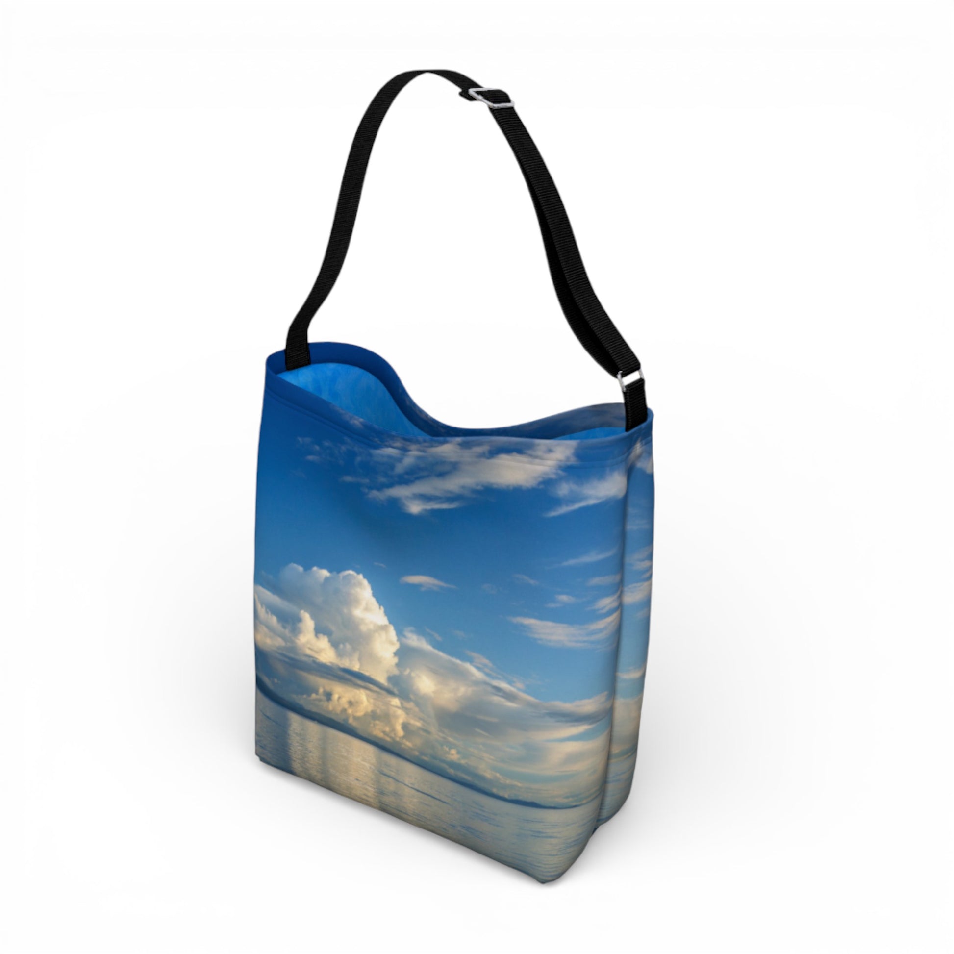 Tote bag with a design of a blue sky and clouds on a white background