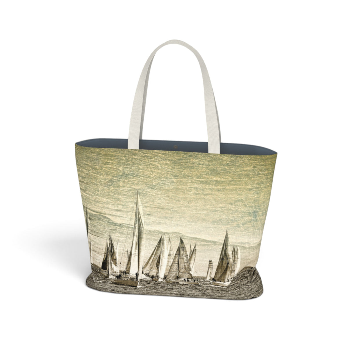 A tote bag featuring a vintage-style print of sailboats on the front, with a dark navy blue interior lining and light beige shoulder straps, shown against a plain white background.