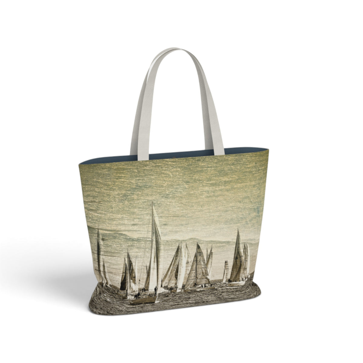 A tote bag featuring a vintage-style illustration of sailboats on the front, with white shoulder straps and a dark navy blue interior lining, shown against a plain white background.