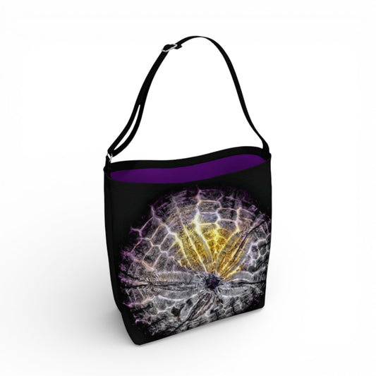 Black tote bag with a sand dollar design on a white background