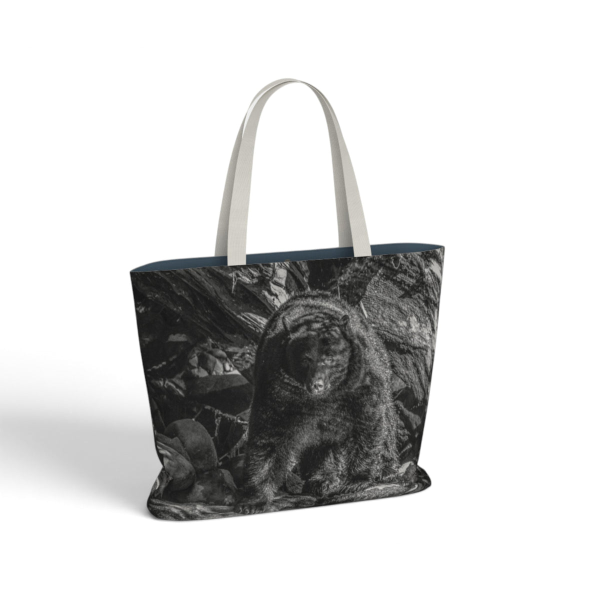 A tote bag with a black and white photographic print of a bearded bear on the front, featuring light gray fabric handles and a dark navy blue inner lining, shown against a plain white background.