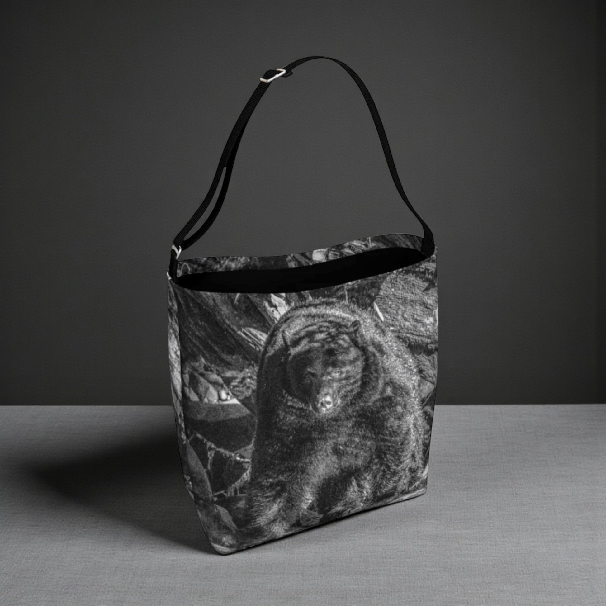 Black and white patterned bag on a gray surface with a dark background