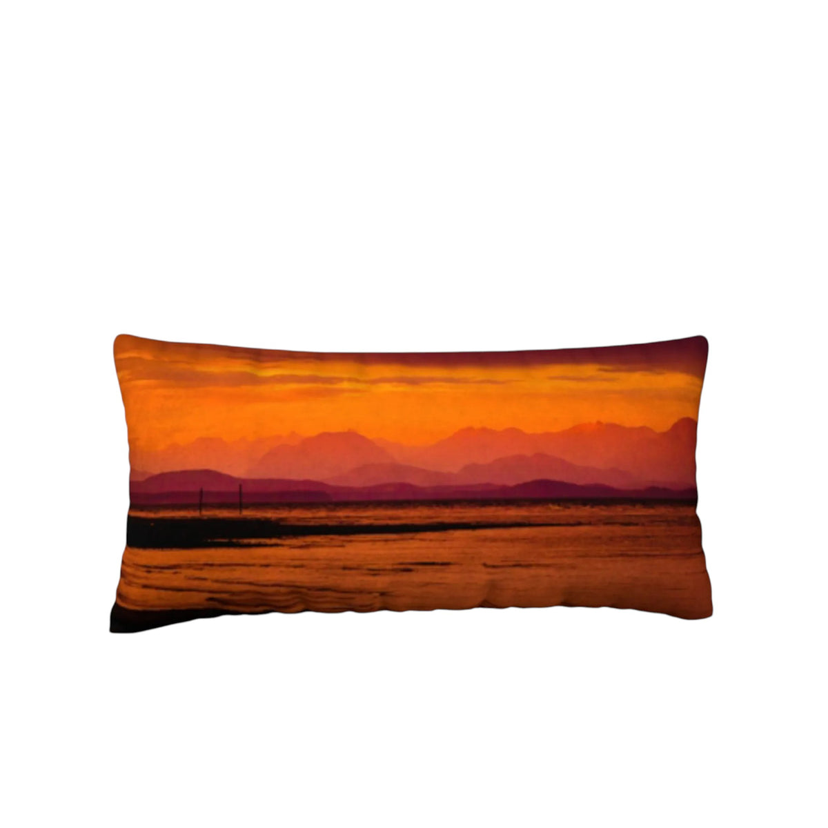 A rectangular lumbar pillow featuring a scenic sunset landscape print with orange and red mountains over a reflective body of water, shown against a plain white background.