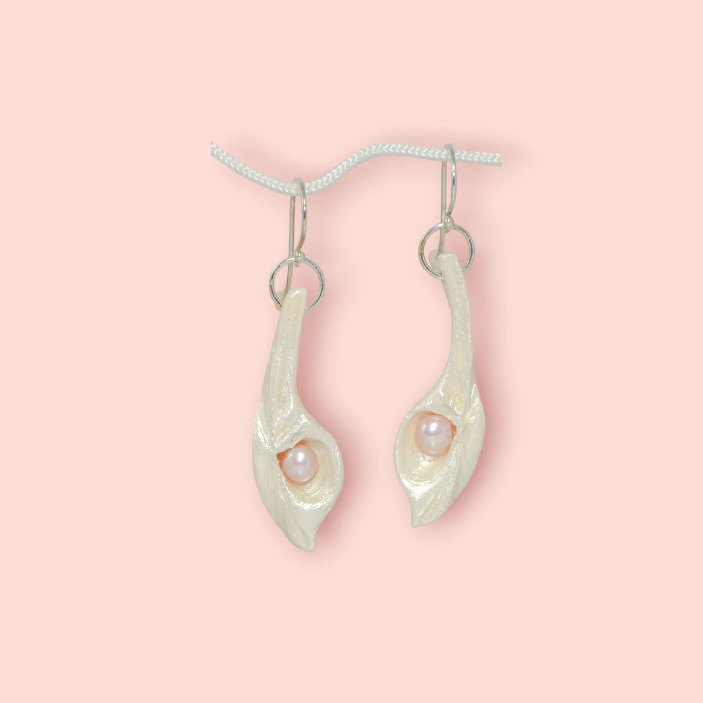 Sea Plume natural seashell earrings with real pink freshwater pearls.