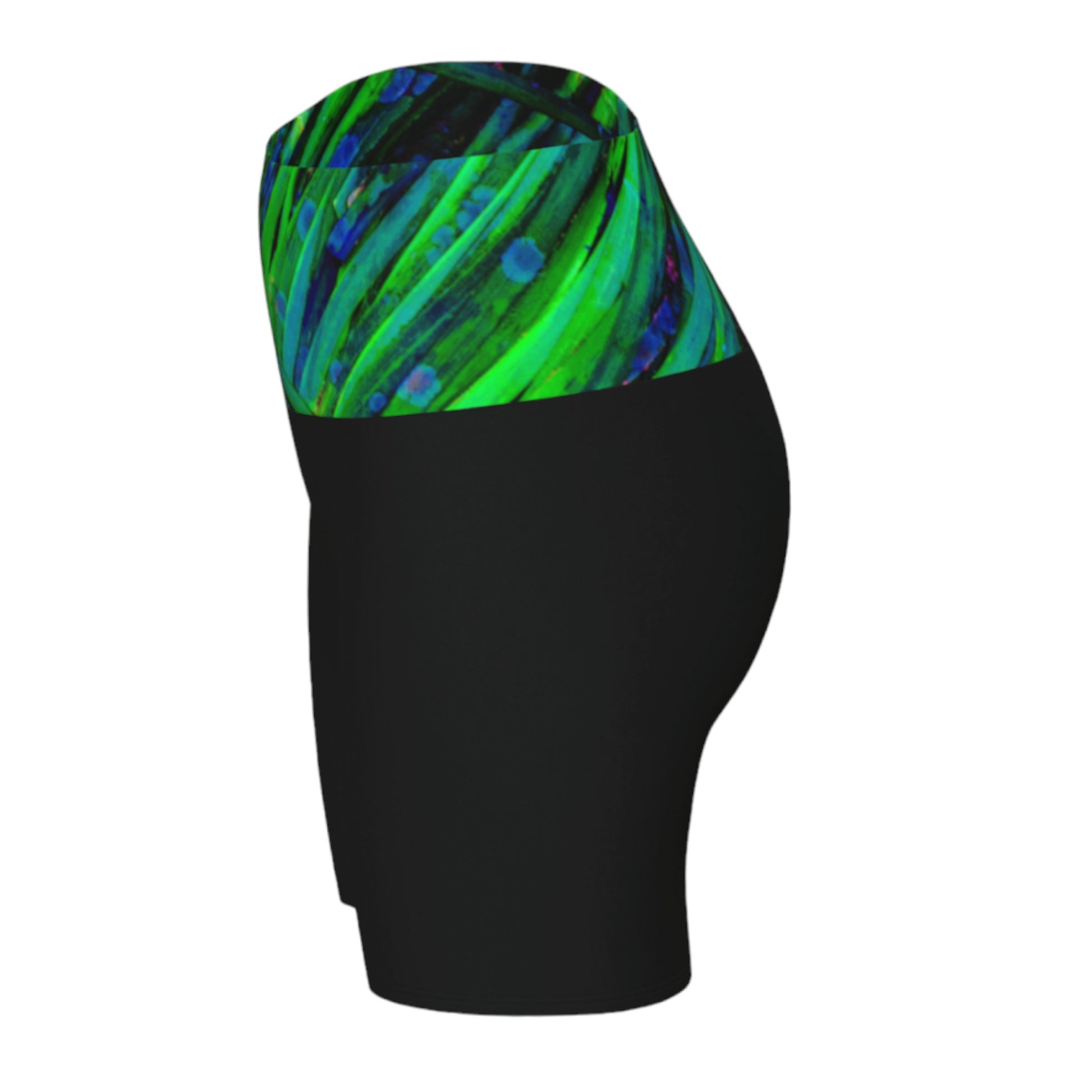 Shades of green yoga shorts features the image of spring green ocean sea grass at low tide. the rest of the shorts are black.