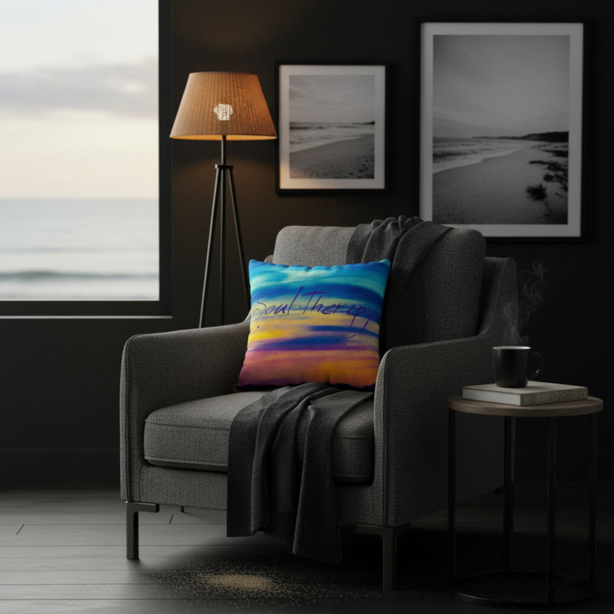 A colorful square throw pillow with a blue, pink, and orange sunset design and the words 'You are enough' in script, styled on a gray armchair in a dark modern living room.